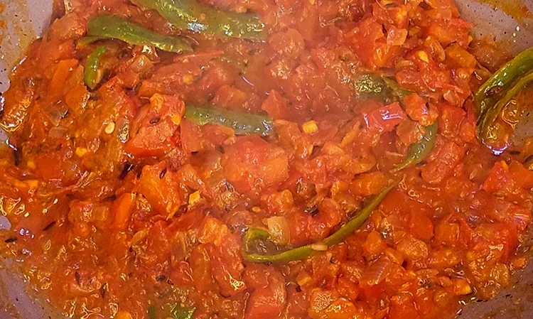 Cook tomatoes till mushy for Mathania Paneer